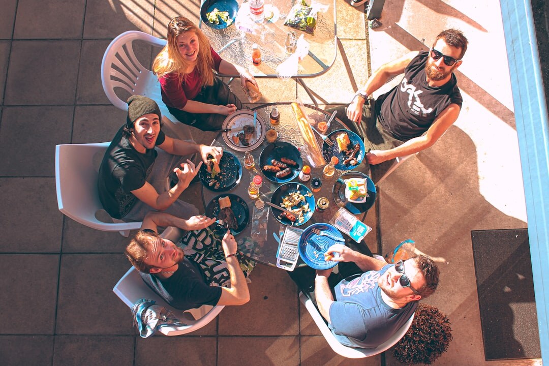 Group of Brazilian coworkers discussing ideas around a table in a modern office