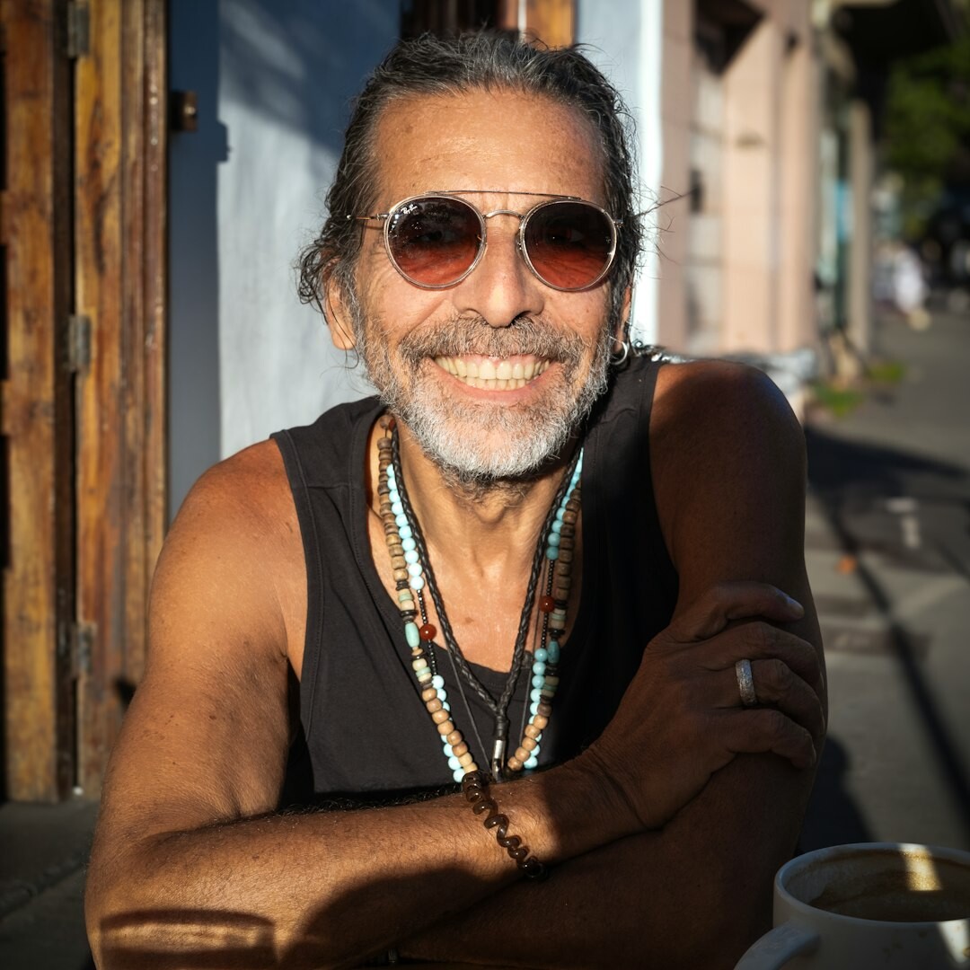 Studio portrait of a Brazilian man with short beard smiling