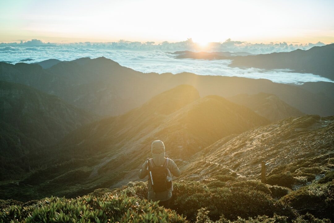 person meditating at sunrise